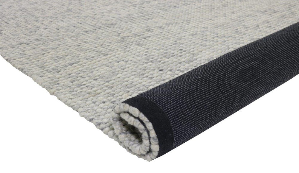 Light grey wool rug braided with cotton in a flatweave construction, with black cotton backing to stop slippage, available for sale in sydney australia.